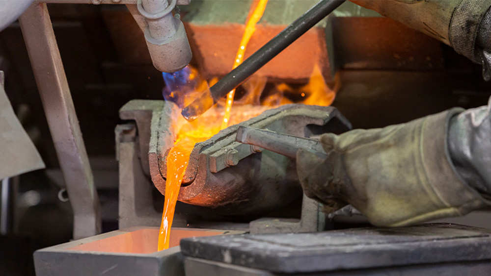 Photo of melted gold being poured. Photo of melted gold being poured.