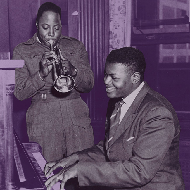 Oscar Peterson at a piano with his brother, Chuck, playing trumpet